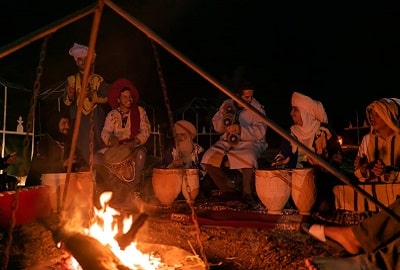 around a campfire merzouga desert camp